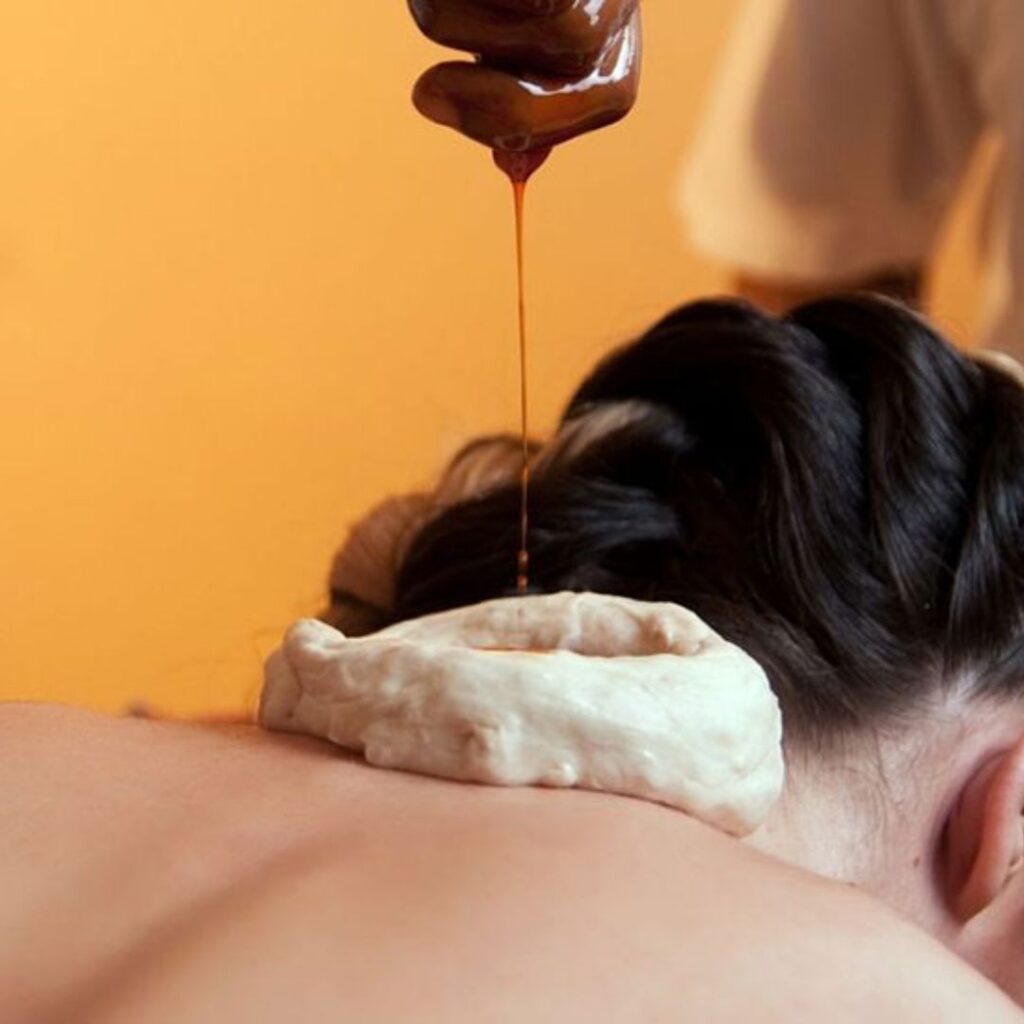 Traditional dhara procedure associated with Panchakarma treatment in Kerala
